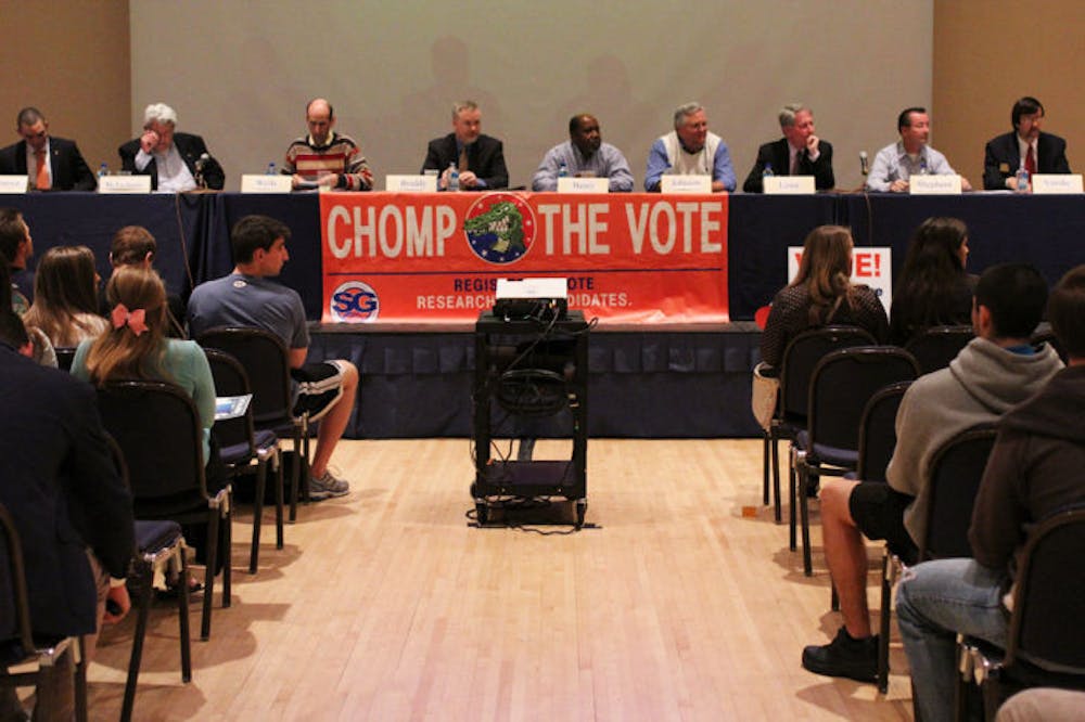 <p>Mayor and City Commission candidates speak to students at the Chomp the Vote forum Wednesday evening at the Reitz Union.</p>