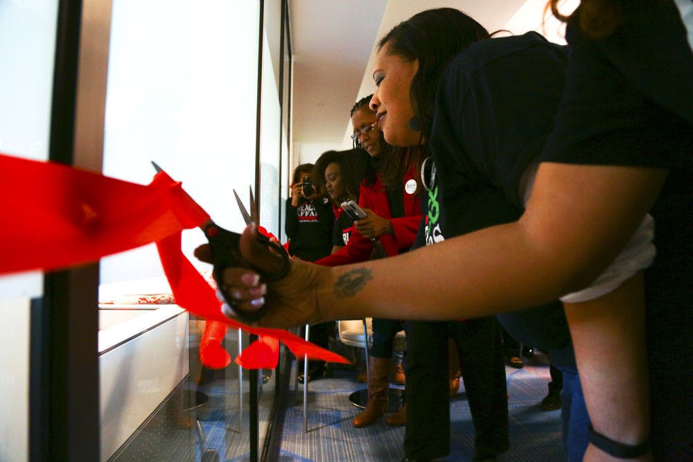 Susan Ajayi (second left), a 22-year-old UF family, youth and community sciences senior, cuts the ribbon along with others at the inauguration of the Black Enrichment Center at the Reitz Union on Thursday.
