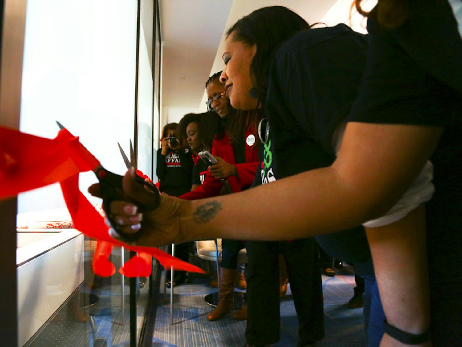 Susan Ajayi (second left), a 22-year-old UF family, youth and community sciences senior, cuts the ribbon along with others at the inauguration of the Black Enrichment Center at the Reitz Union on Thursday.