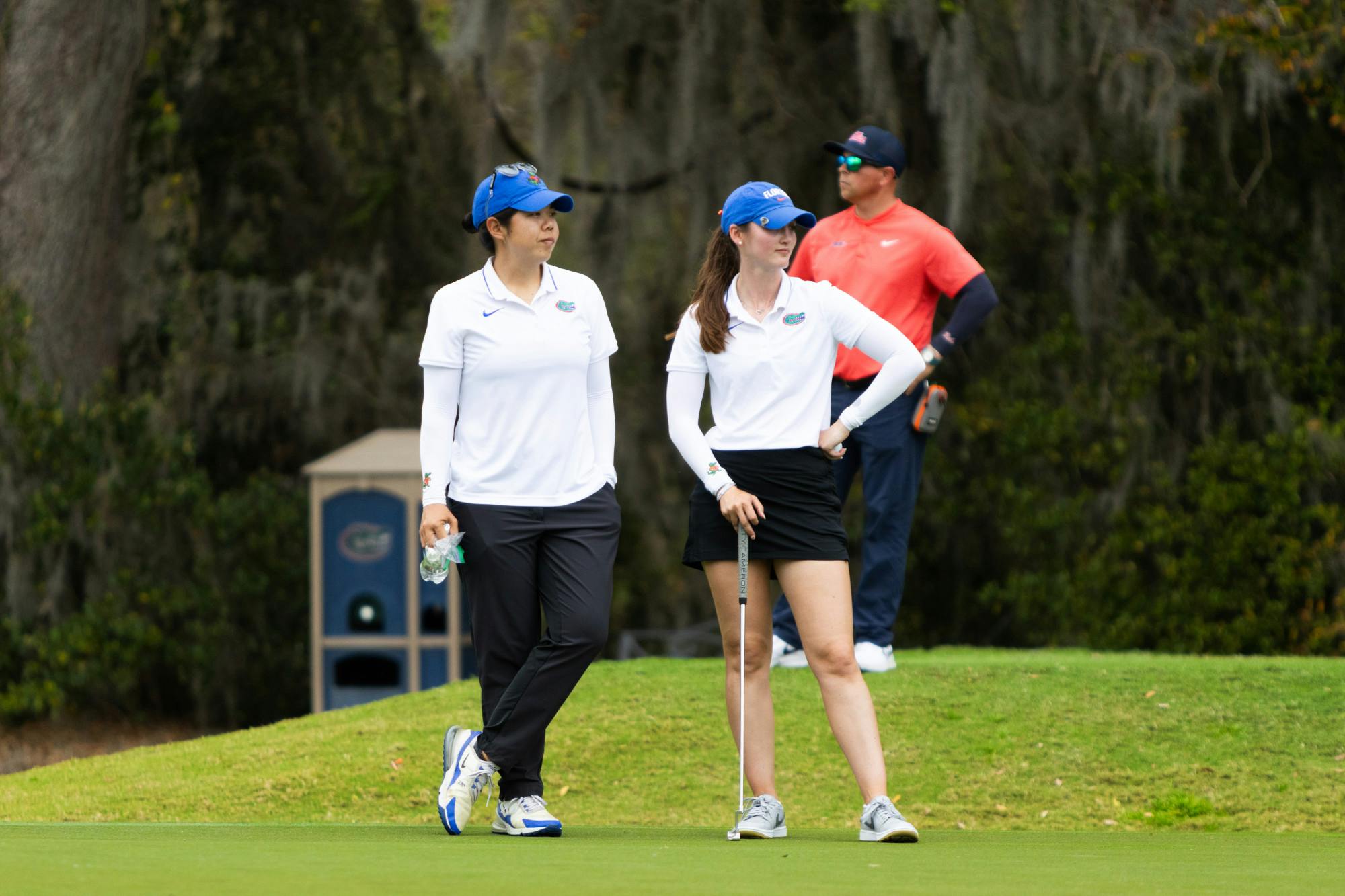 Gators women's senior golfer Maisie Filler and assistant coach Beth Wu look on at the Gators Invitational on Friday, March 1, 2024. 