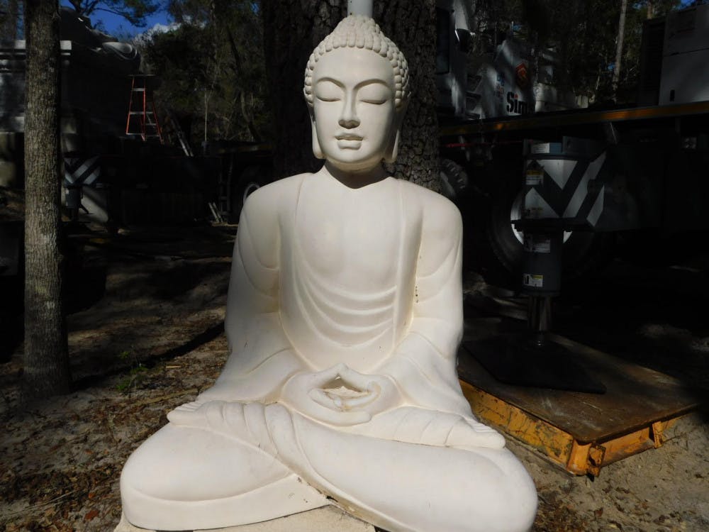 The smaller sitting Buddha weighs 66,138.7 pounds. 