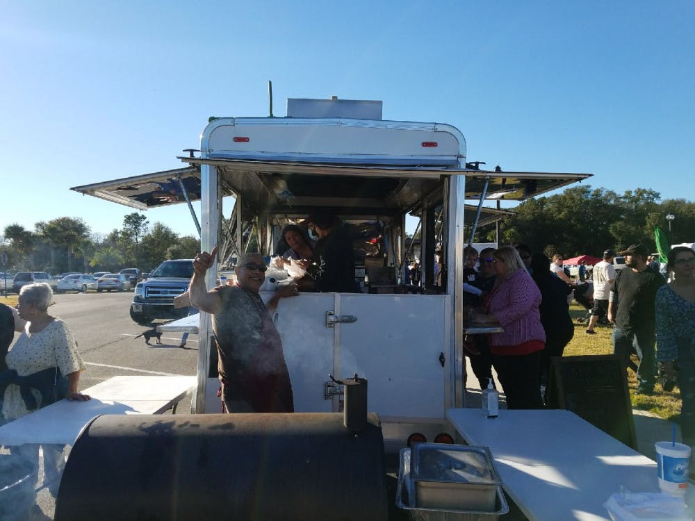 <p><span>Guillermo Gonzalez Sr., 52, gives a thumbs up in front of his food truck, El Punto, at Newberry’s First Food Truck Festival Jan. 6.</span> Courtesy to The Alligator</p>