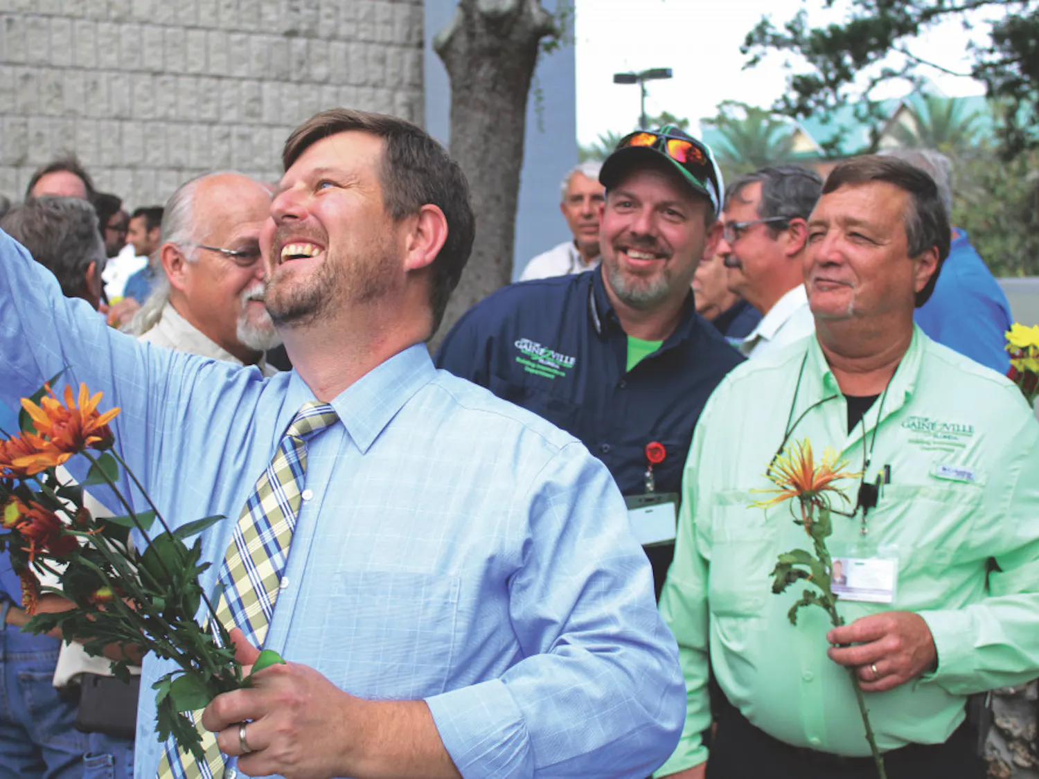Gainesville Mayor Lauren Poe takes a selfie with city workers in front of Gainesville City Hall, located at 200 E. University Ave., on Thursday. Poe and city commissioners gave flowers to thank workers for helping after Hurricane Irma.