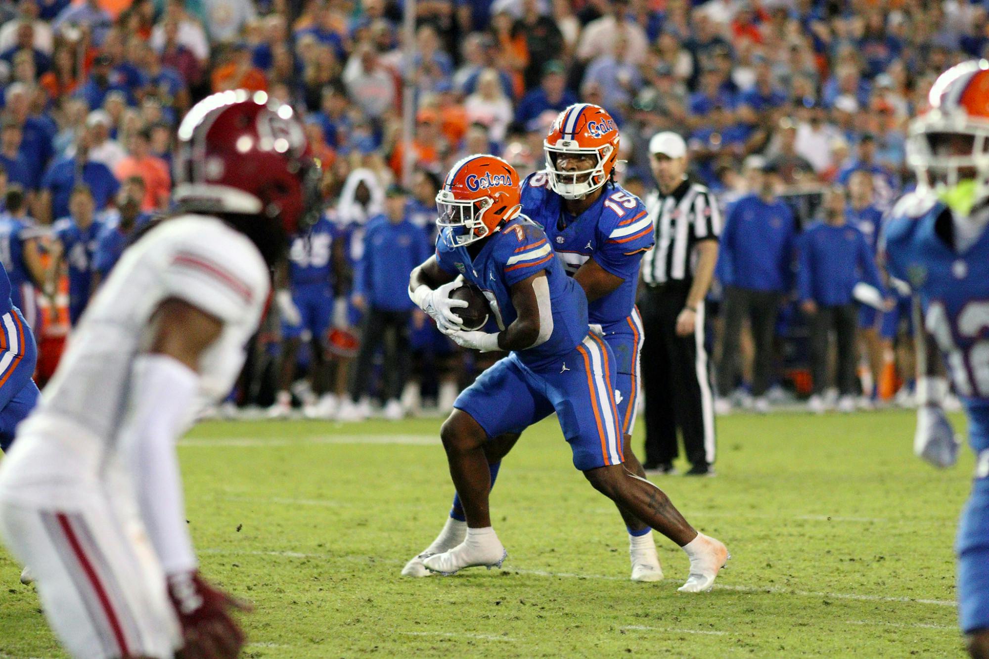 Quarterback Anthony Richardson hands the ball off to running back Trevor Etienne during Florida&#x27;s win over South Carolina Saturday, Nov. 12, 2022. ﻿