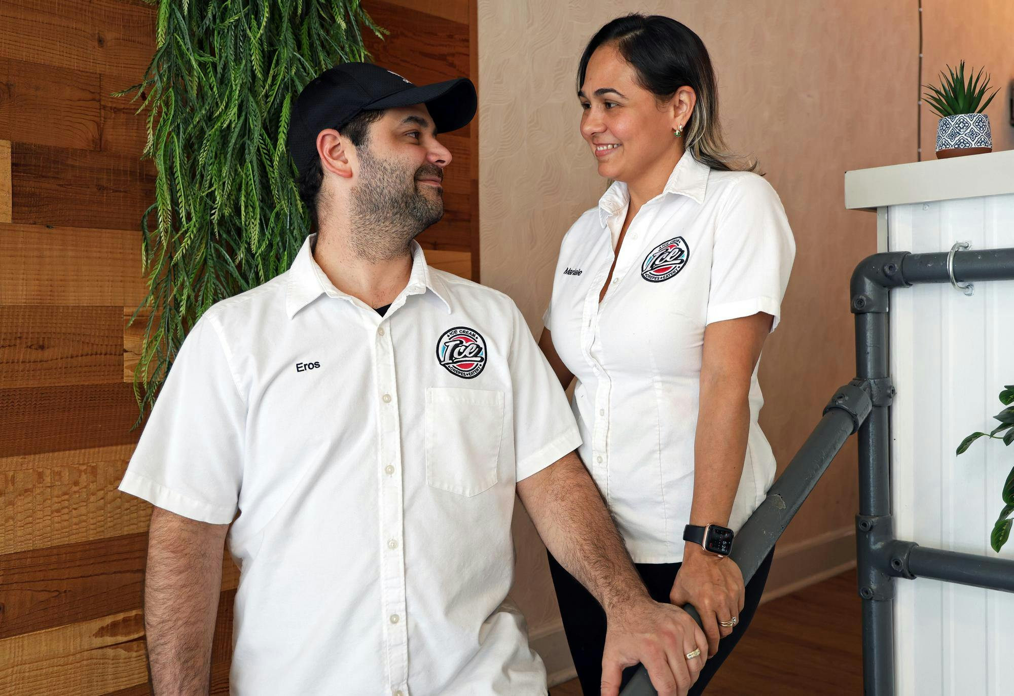 Eros Puentes (left) and Marialejandra “Mariale” Puentes (right) smile at each other in their restaurant, La Maracucha, on May 21, 2025. 