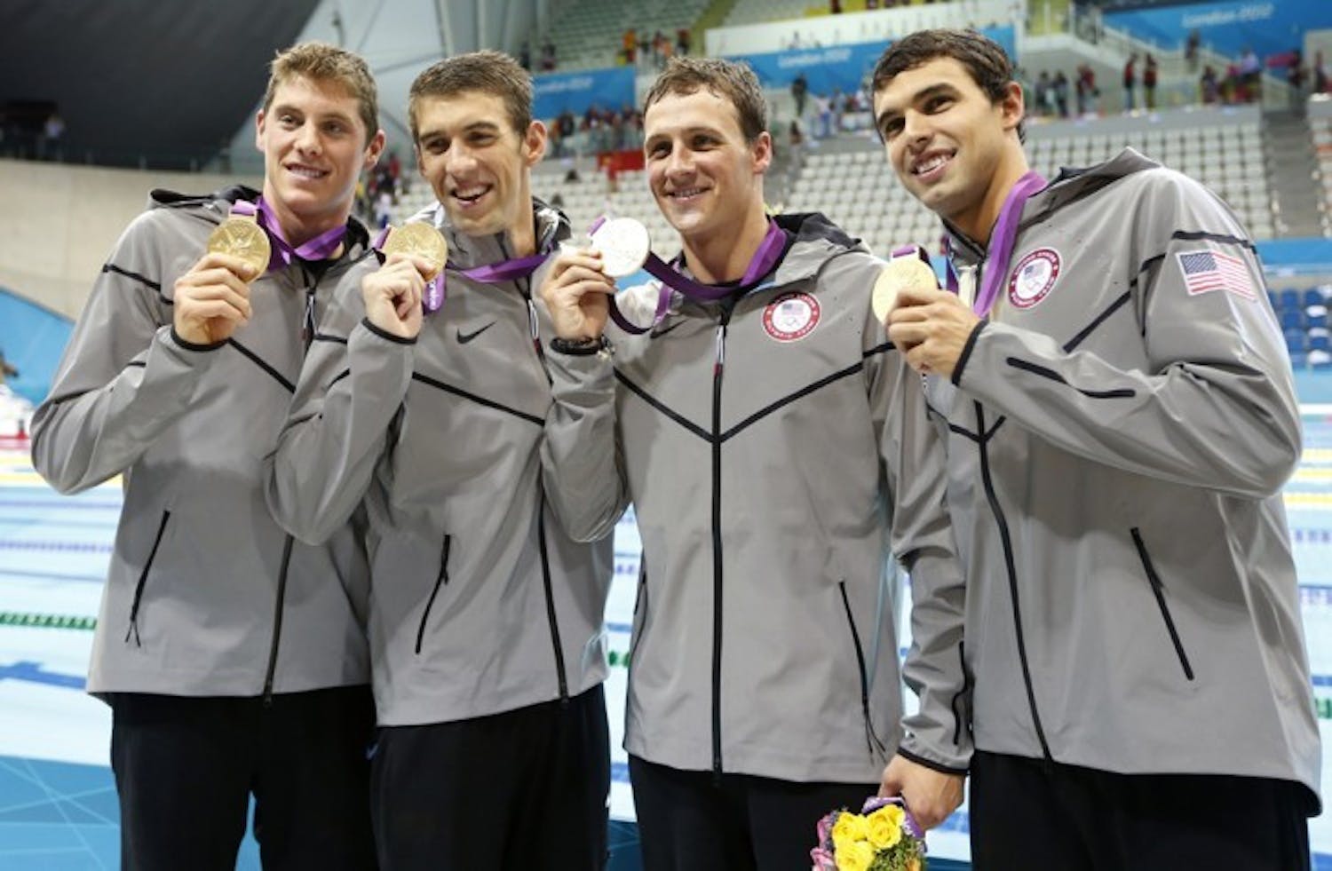Former Gators Conor Dwyer (left) and Ryan Lochte (third from left) show off their gold medals after winning the 4x200-meter freestyle relay with a time of 6:59.70 at the 2012 London Olympics.&nbsp;