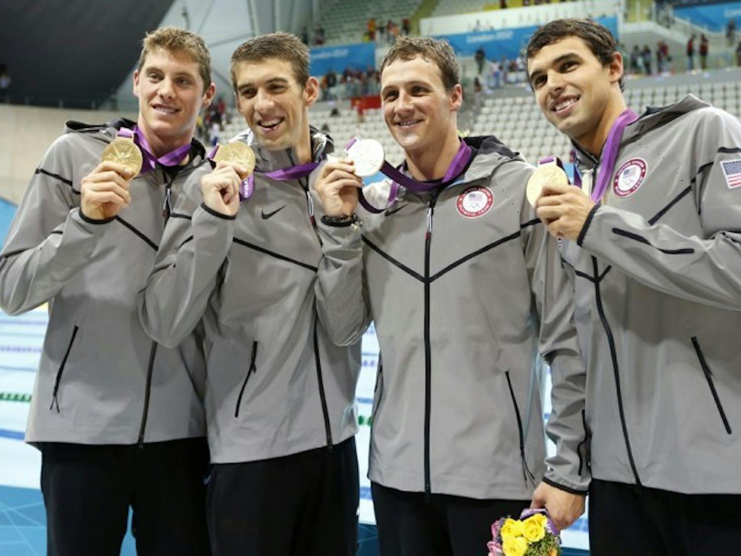 Former Gators Conor Dwyer (left) and Ryan Lochte (third from left) show off their gold medals after winning the 4x200-meter freestyle relay with a time of 6:59.70 at the 2012 London Olympics.&nbsp;