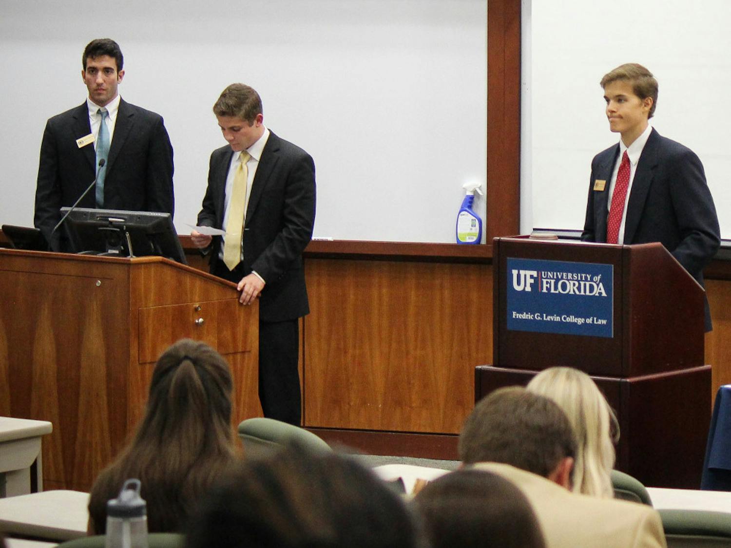 Sen. Jason Richards (center) presents the resolution supporting the installation of solar power-doks on campus on Tuesday evening.
