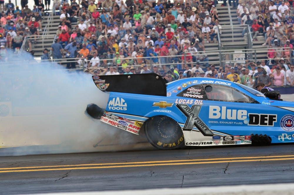 John Force races down the quarter-mile track at the Auto Plus Raceway in Gainesville during the 2015 Gatornationals on Saturday.