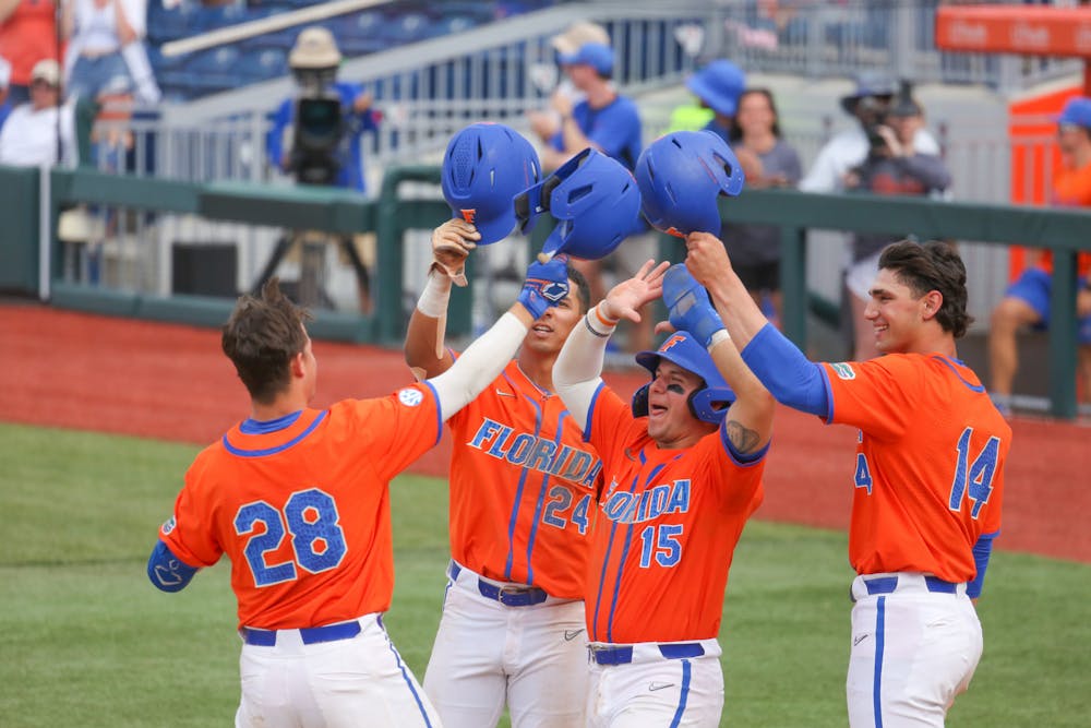 Catcher Luke Heyman celebrates with his teammates after he hit a grand slam in the bottom of the eighth in a 17-8 victory against the Auburn Tigers Sunday, April 2, 2023. 