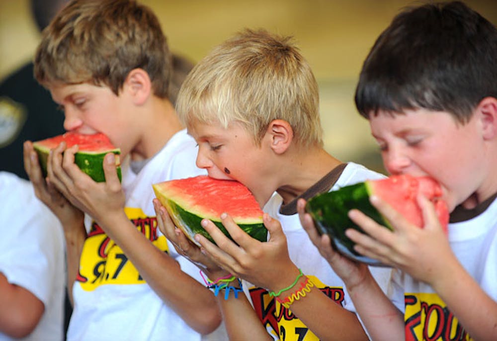 <p>Zion Barber, left, Jacob Musselwhite and Colton Crane, right, sink their teeth into pieces of watermelon during the watermelon-eating contest at the 65th annual Newberry Watermelon Festival at the Canterbury Equestrian Showplace in 2010.</p>
