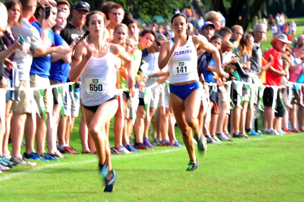 <p>UF's Becky Greene (right) races to the finish during the Mountain Dew Invitational on Sept. 19, 2015, at the Mark Bostick Golf Course.</p>