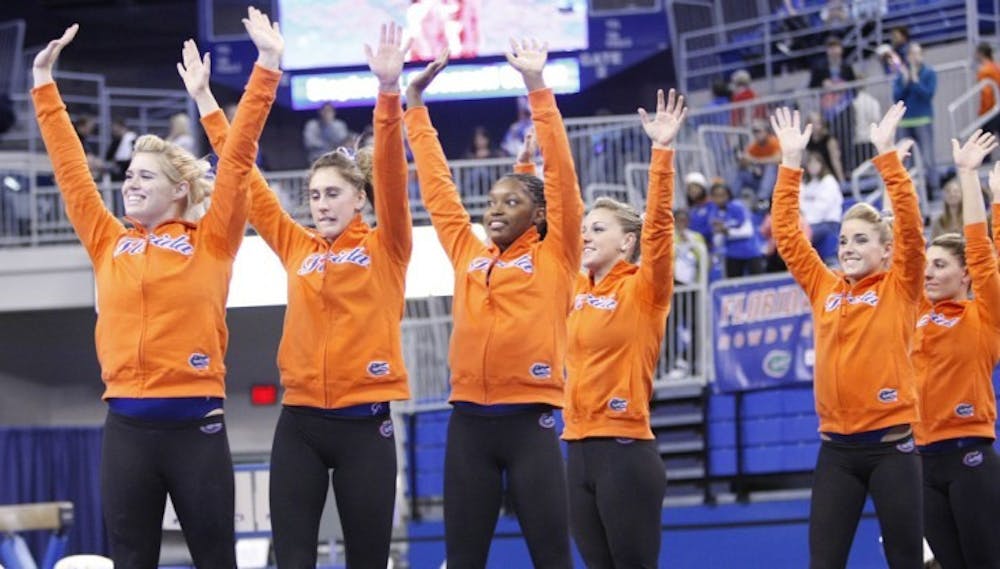 <p>Florida gymnasts (from left to right) Jamie Shisler, Lauren Rose, Ashanée Dickerson, Dali Lemezan, Amy Ferguson and Nicole Ellis wave to the crowd after winning a meet against Illinois-Chicago on Jan. 13. Florida is competing at the NCAA Championships semifinal today.</p>