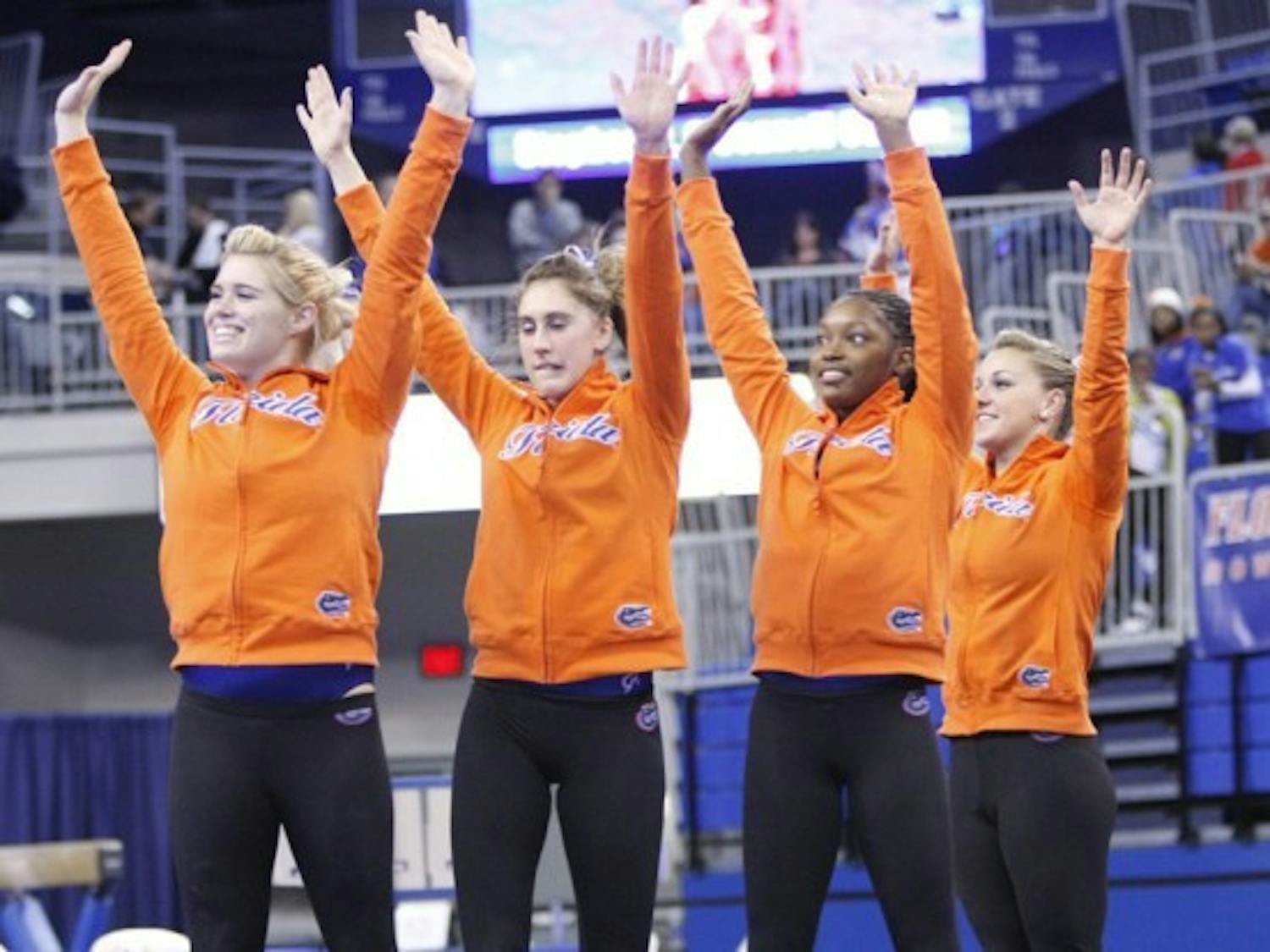Florida gymnasts (from left to right) Jamie Shisler, Lauren Rose, Ashanée Dickerson, Dali Lemezan, Amy Ferguson and Nicole Ellis wave to the crowd after winning a meet against Illinois-Chicago on Jan. 13. Florida is competing at the NCAA Championships semifinal today.