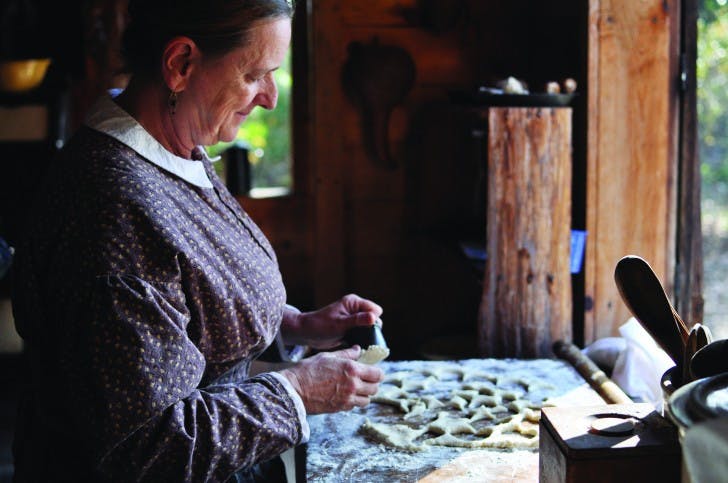 Teresa Glaser makes homemade biscuits for patrons to enjoy at the Annual Cane Boil &amp; FiddleFest at Morningside Nature Center. Glaser said she hopes visitors remember more than just the taste of the festival’s handmade foods.