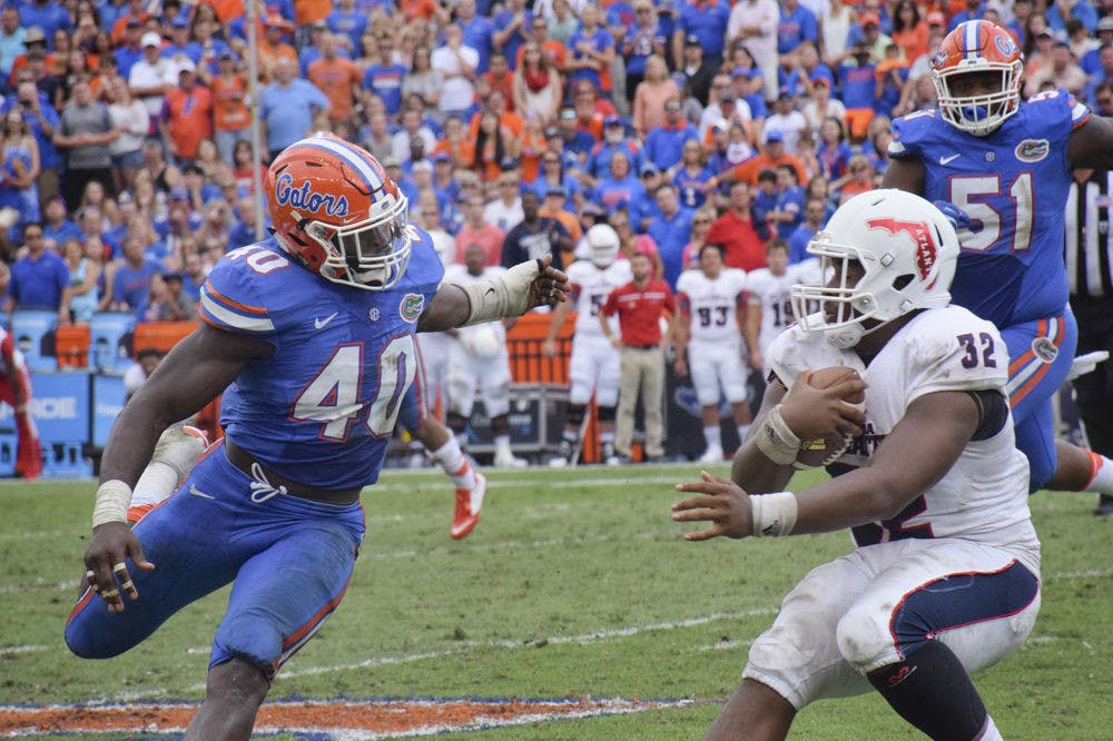 UF linebacker Jarrad Davis pursues FAU quarterback Jaquez Johnson during Florida's 20-14&nbsp;overtime win against Florida Atlantic on Nov. 21, 2015, at Ben Hill Griffin Stadium.