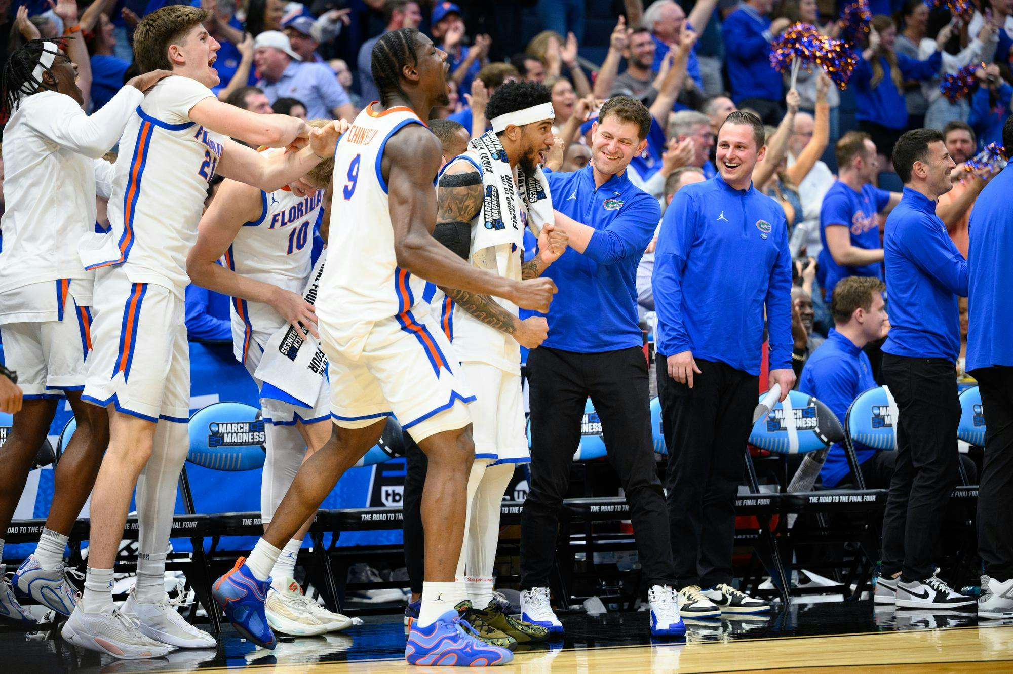 Florida guard Boogie Fland (0) and center Rueben Chinyelu (9) celebrate with the bench after 7-foot-9 center Olivier Rioux (32) scores during the second half of an NCAA Tournament first round game against Prairie View A&M, Friday, March 20, 2026, in Tampa, Fla.