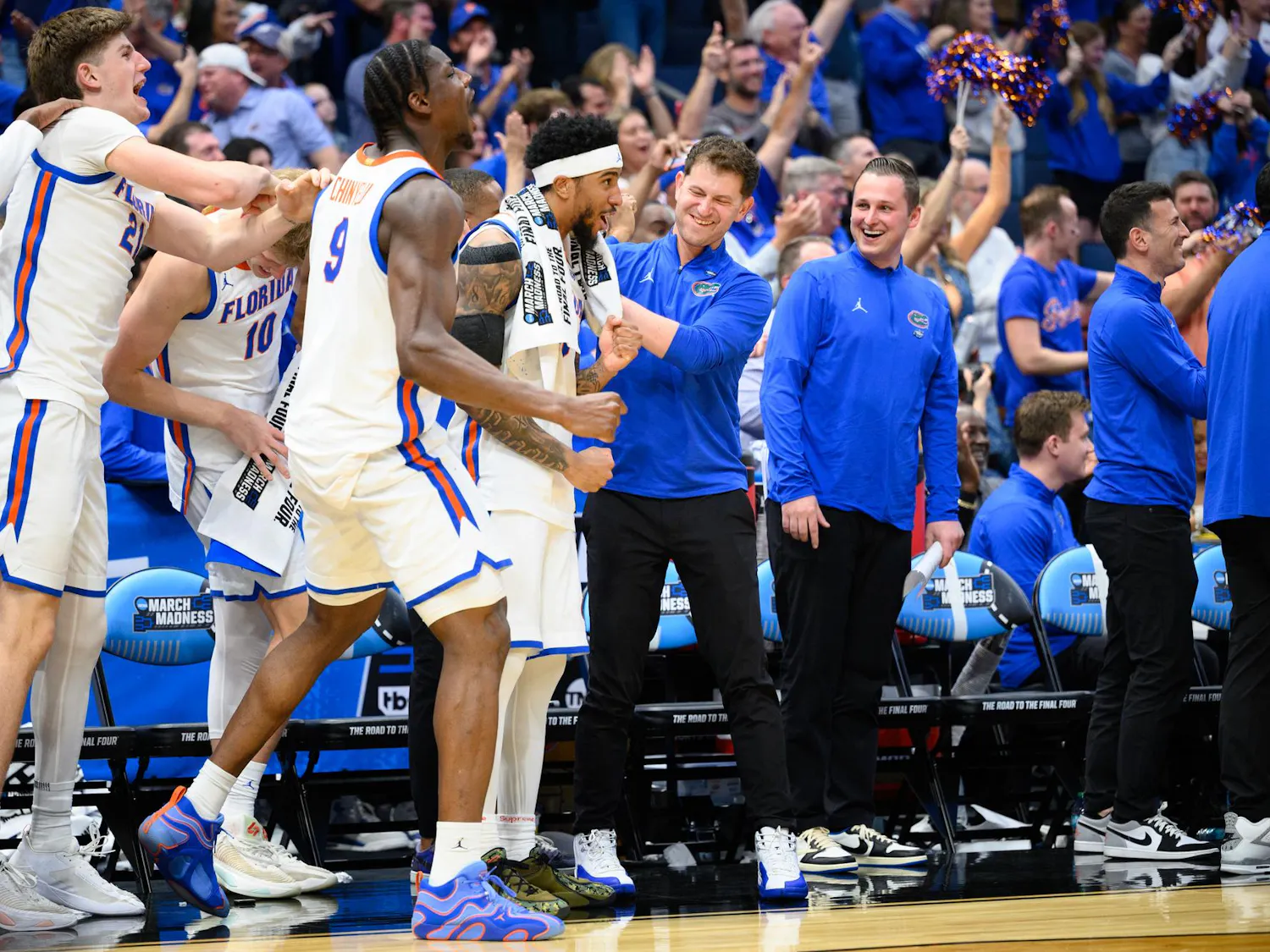 Florida guard Boogie Fland (0) and center Rueben Chinyelu (9) celebrate with the bench after 7-foot-9 center Olivier Rioux (32) scores during the second half of an NCAA Tournament first round game against Prairie View A&M, Friday, March 20, 2026, in Tampa, Fla.