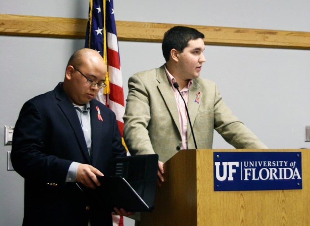 <p>Student Body President Anthony Reynolds and former Student Body President Ben Meyers address the Student Senate meeting Tuesday night.</p>