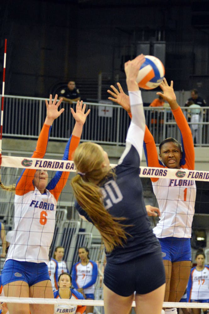 Rhamat Alhassan (1) attempts a block during Florida's 3-0 win against Ole Miss on Sunday in the O'Connell Center.