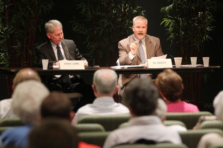 Mayor Craig Lowe and mayoral candidate Ed Braddy debate at Oak Hammock at UF retirement community Tuesday night. About 90 people attended.
