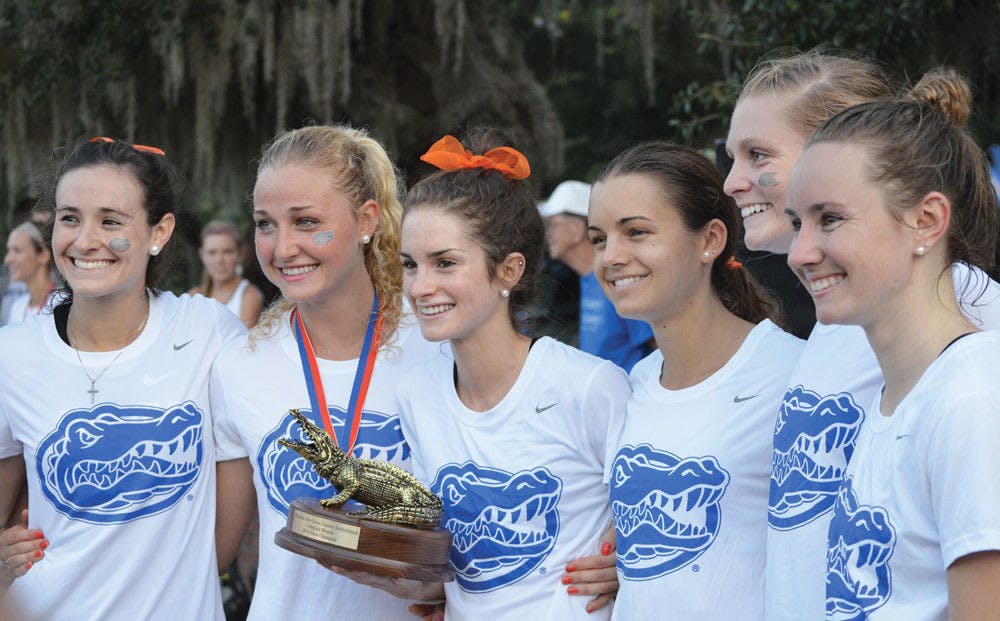The Florida women's cross country team accepts its first-place trophy at the 2014 Mountain Dew Invitational