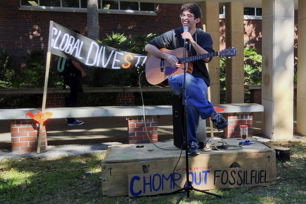 <p>Ricky Brockway, a 21-year-old independent musician, sings in front of Library West on Divestment Day, an event put on by I.D.E.A.S of UF. His solo performance goes by the title "Moose".</p>