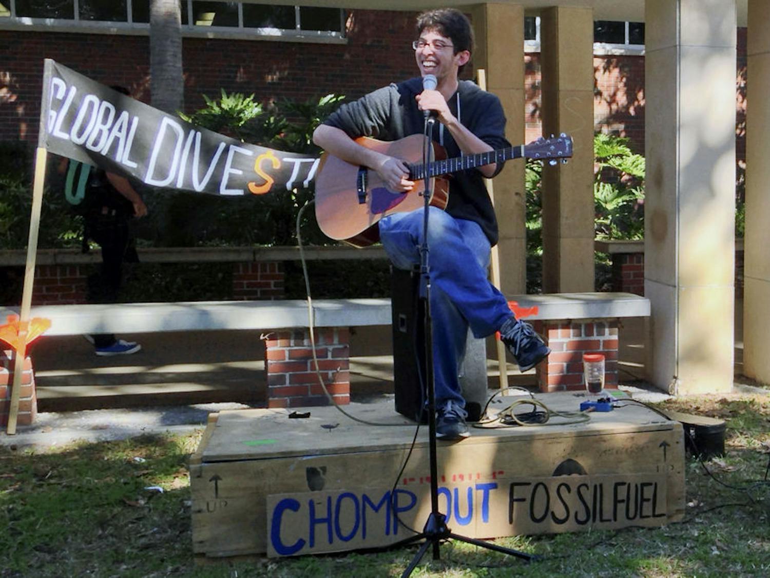 Ricky Brockway, a 21-year-old independent musician, sings in front of Library West on Divestment Day, an event put on by I.D.E.A.S of UF. His solo performance goes by the title "Moose".