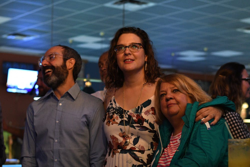 State Senate candidate and Gainesville Democrat Olysha Magruder anxiously awaits election results with her husband James McRae and mother Karen Magruder at the Palomino Pool Hall on Tuesday night. Magruder lost the election.