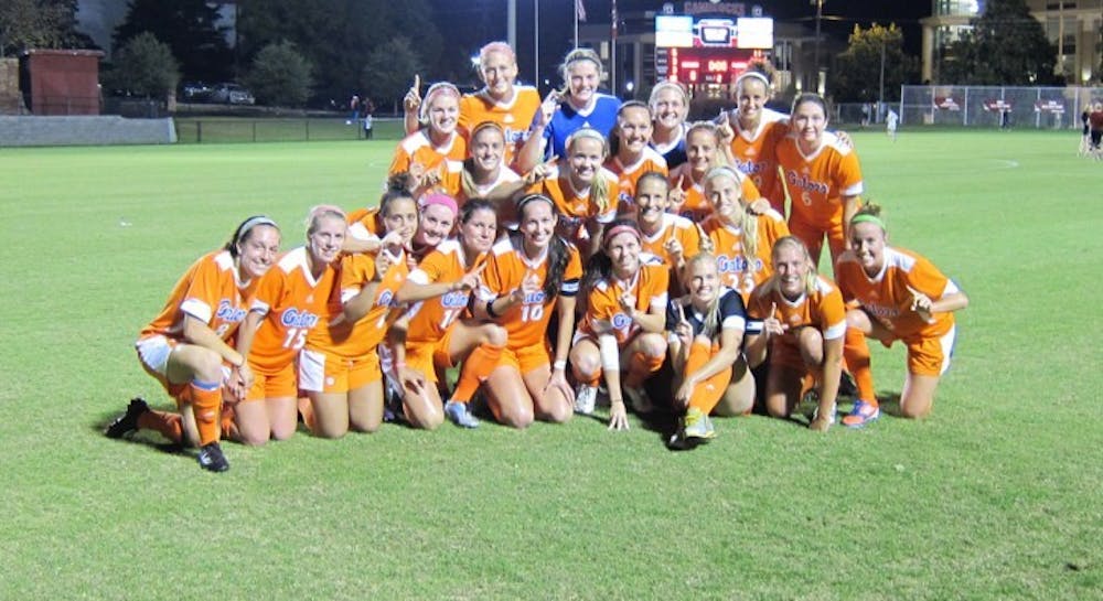 <p>The Gators soccer team poses for a photograph following their 3-0 victory against South Carolina on Thursday in Columbia, S.C. UF clinched its second SEC championship in three years.</p>