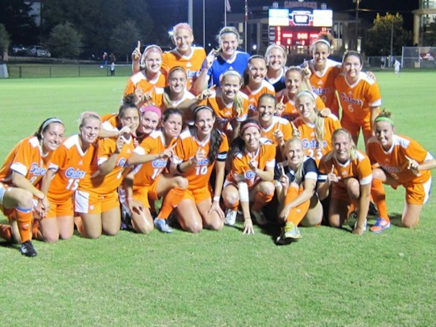 The Gators soccer team poses for a photograph following their 3-0 victory against South Carolina on Thursday in Columbia, S.C. UF clinched its second SEC championship in three years.