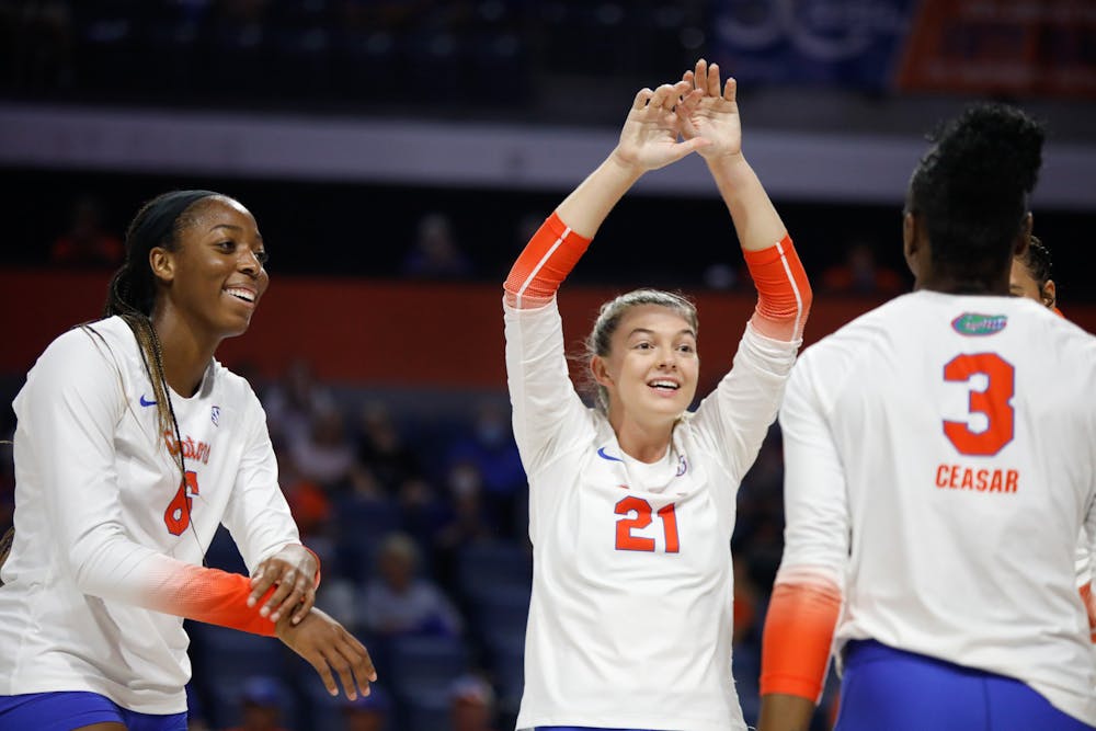 Florida volleyball players Marlie Monserez (21), Nnedi Okammor (6) and T'ara Ceaser celebrate during a game against Mississippi State on Sept. 24.
