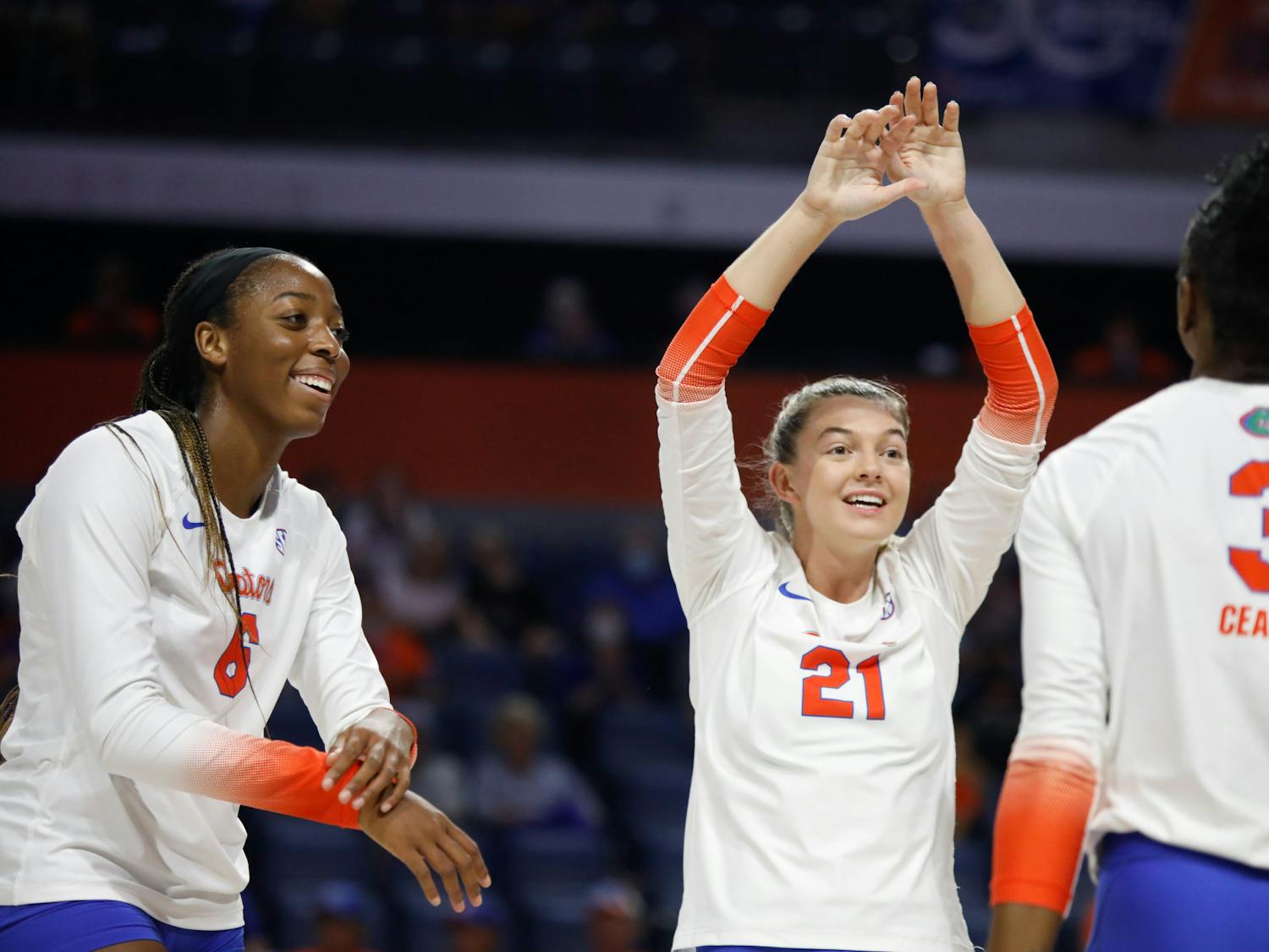Florida volleyball players Marlie Monserez (21), Nnedi Okammor (6) and T'ara Ceaser celebrate during a game against Mississippi State on Sept. 24.