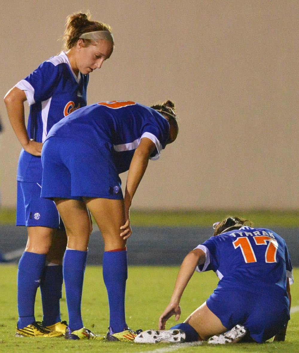 <p>Senior Erika Tymrak (17) reaches for her leg after falling to the ground during Florida's game against Tennessee at James G. Pressly Stadium on Friday. Tymrak didn't play when Florida hosted Georgia.</p>