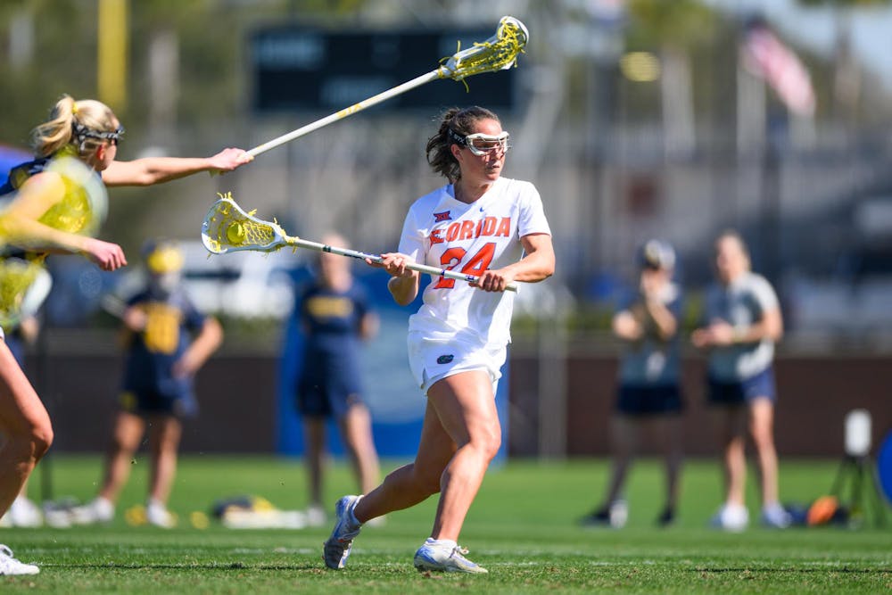 Florida midfielder Gabbi Koury (24) shoots during the first half of an NCAA lacrosse match against Michigan, Friday, Feb. 13, 2026, in Gainesville, Fla.