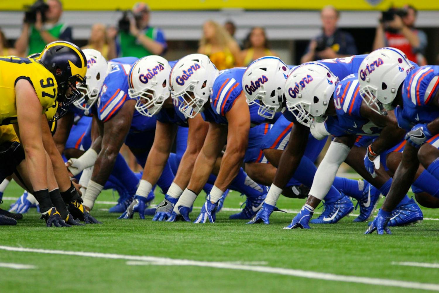 UF's defensive line waits for the snap in Florida's 33-17 loss to Michigan on Saturday in AT&amp;T Stadium in Arlington, Texas.