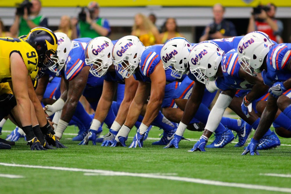 <p>UF's defensive line waits for the snap in Florida's 33-17 loss to Michigan on Saturday in AT&amp;T Stadium in Arlington, Texas.</p>