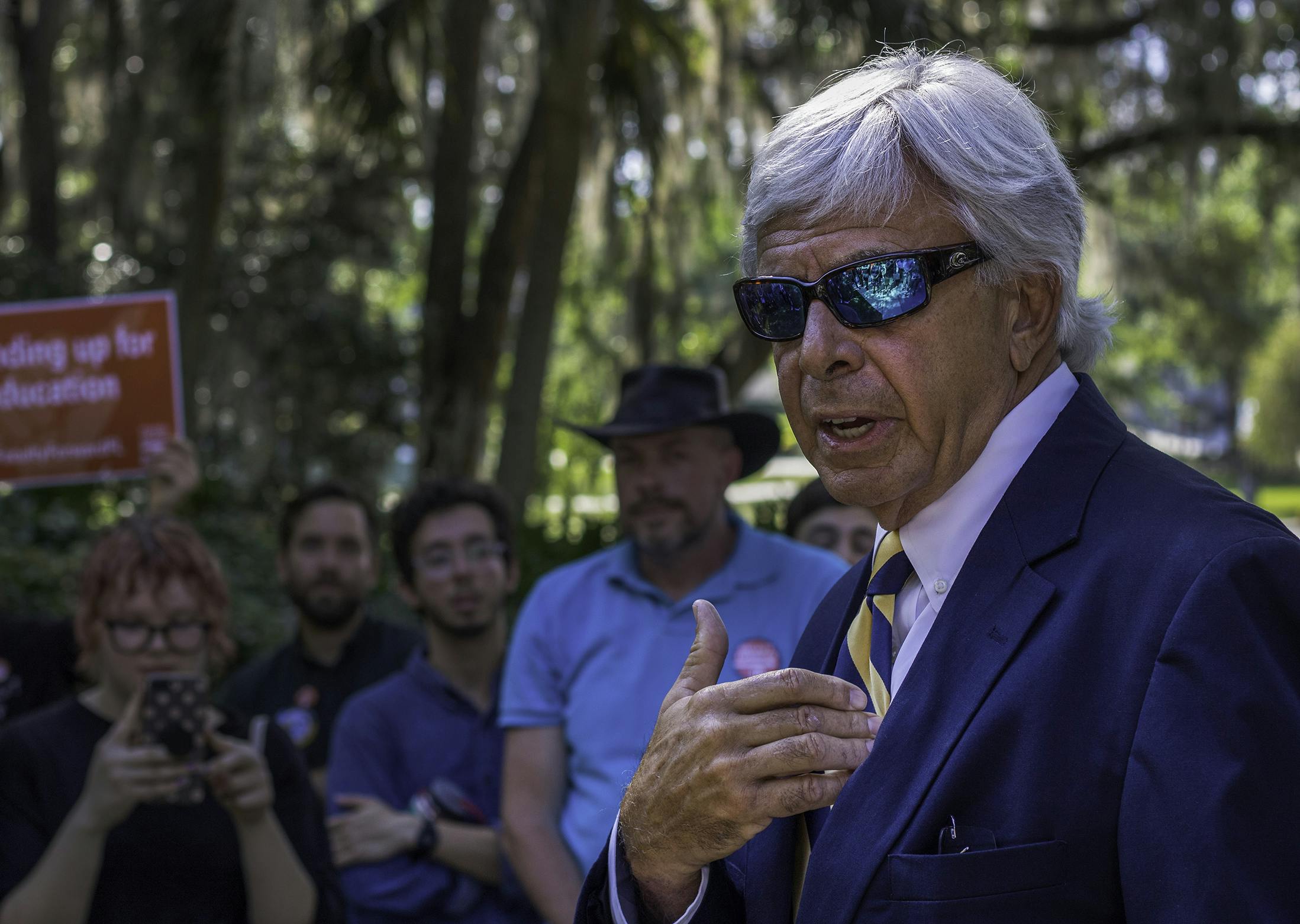 Jackson Sasser, the president of Santa Fe College, addresses a crowd of about 60 protesters Tuesday afternoon on campus. The crowd, made up of faculty, students and other activists, gathered during a Board of Trustees meeting to pressure administrators into giving adjunct faculty a vote on whether or not to join a union. Protesting faculty members believe the administration has taken steps to avoid the formation of a union.