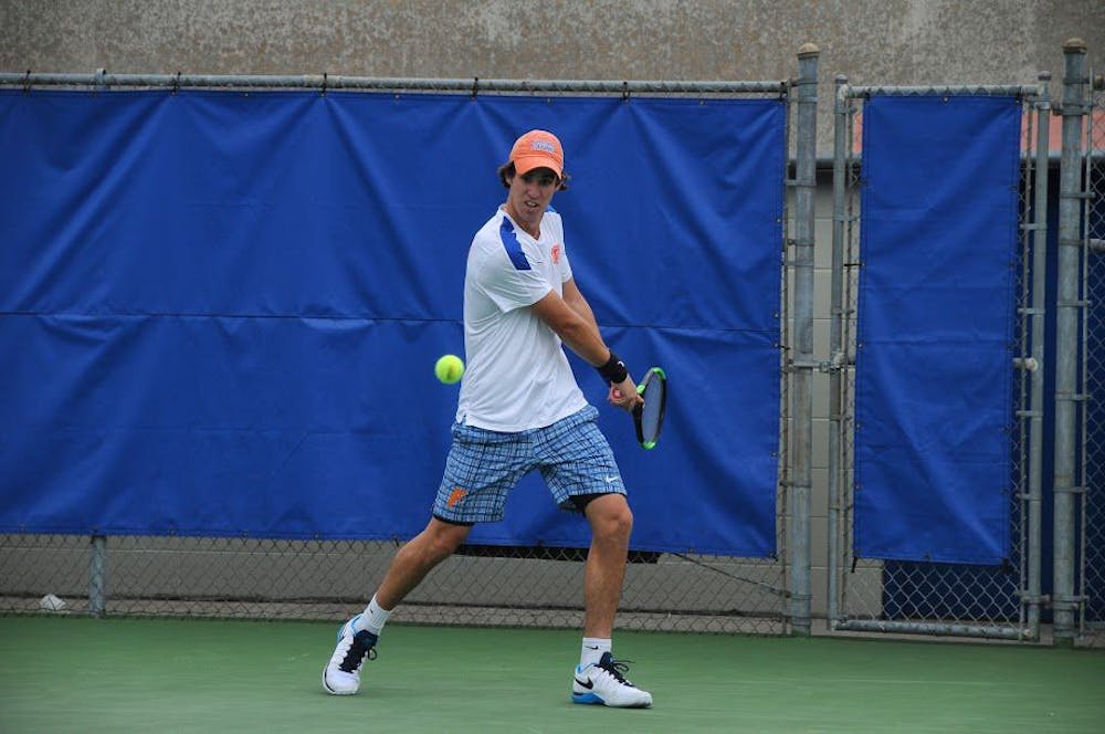 <p>UF's Alfredo Perez hits a backhand during Florida's 4-0 win against UNC Wilmington on Jan. 28, 2017, at the Ring Tennis Complex.</p>