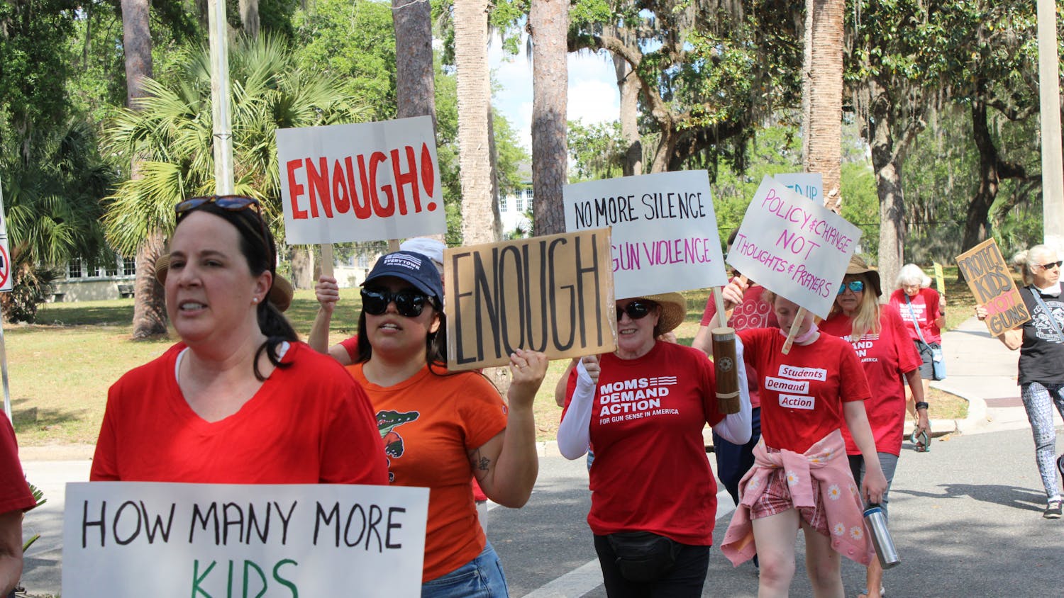 Protesters with the Alachua County chapter of Moms Demand Action march down University Avenue on Tuesday, April 4, 2023.