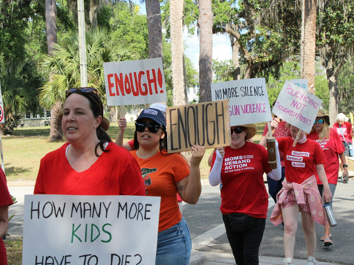 Protesters with the Alachua County chapter of Moms Demand Action march down University Avenue on Tuesday, April 4, 2023.