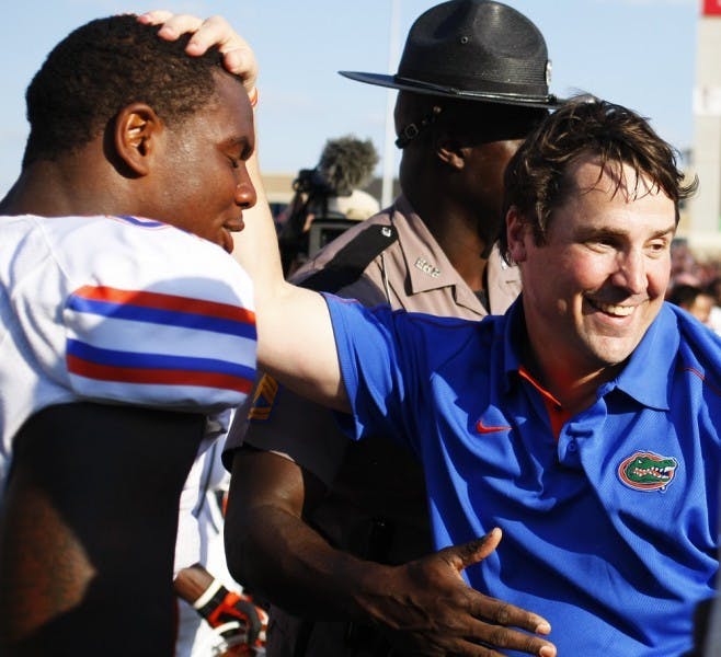 UF coach Will Muschamp congratulates defensive lineman Dominique Easley after Florida's 20-17 win against Texas A&amp;M Saturday at Kyle Field.
&nbsp;
