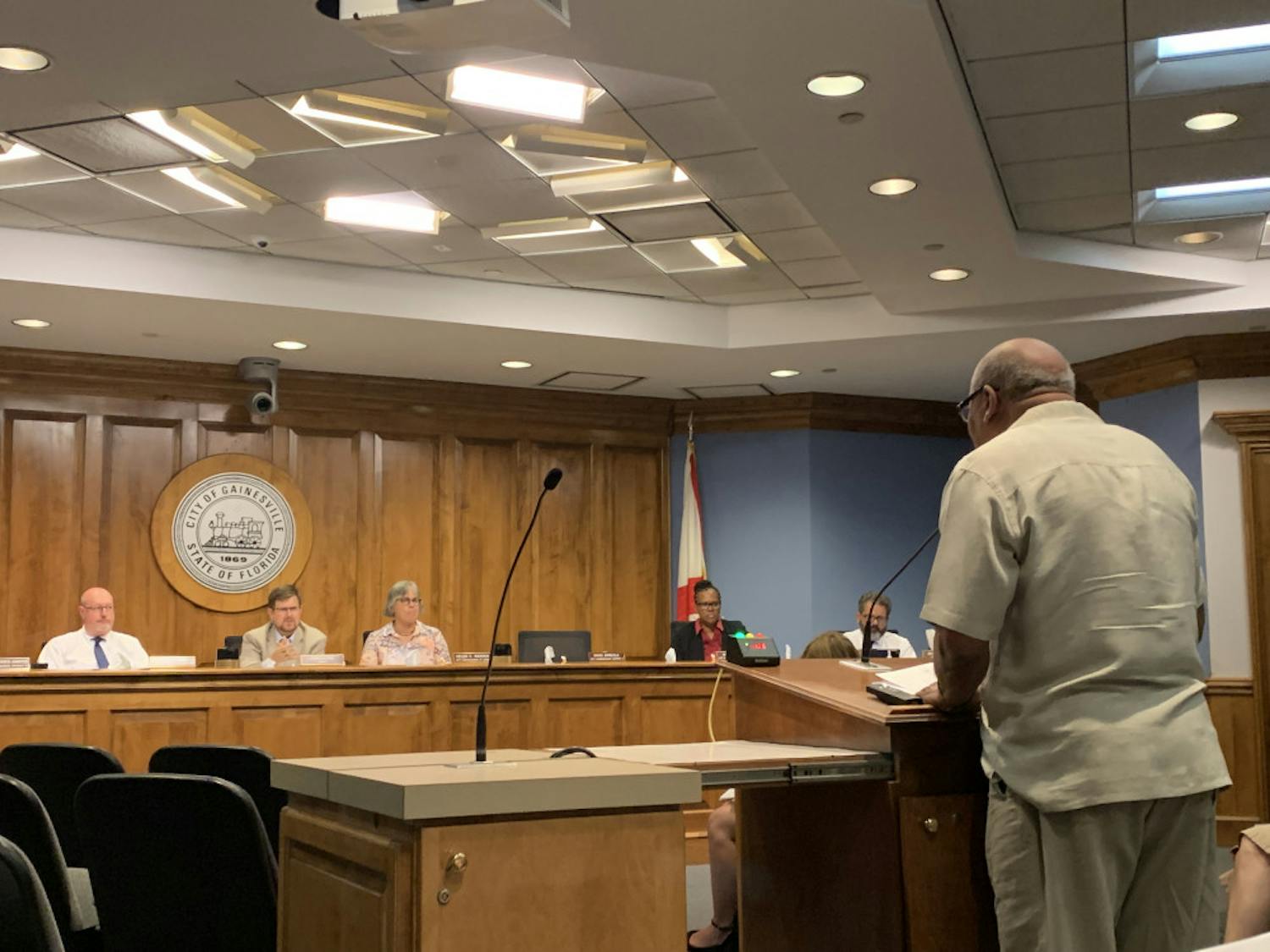 Aaron Green, a 73-year-old Gainesville resident, speaks to the city commission Thursday night about polystyrene cups and containers. Green said the discussions about possibly banning single-use plastics was affecting his business, Fletcher’s Cocktail Lounge, which is located at 619 NW 5th Ave.
