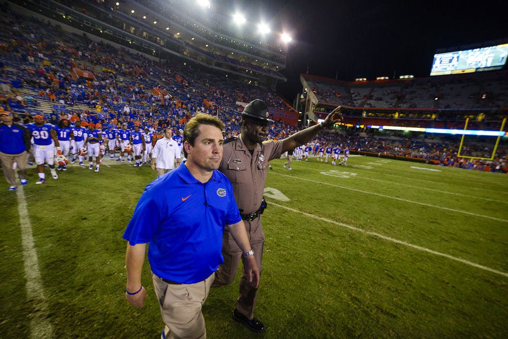 <p>Will Muschamp walks onto the field for the post-game handshake following Florida's 42-13 loss to Missouri on Saturday at Ben Hill Griffin Stadium.</p>