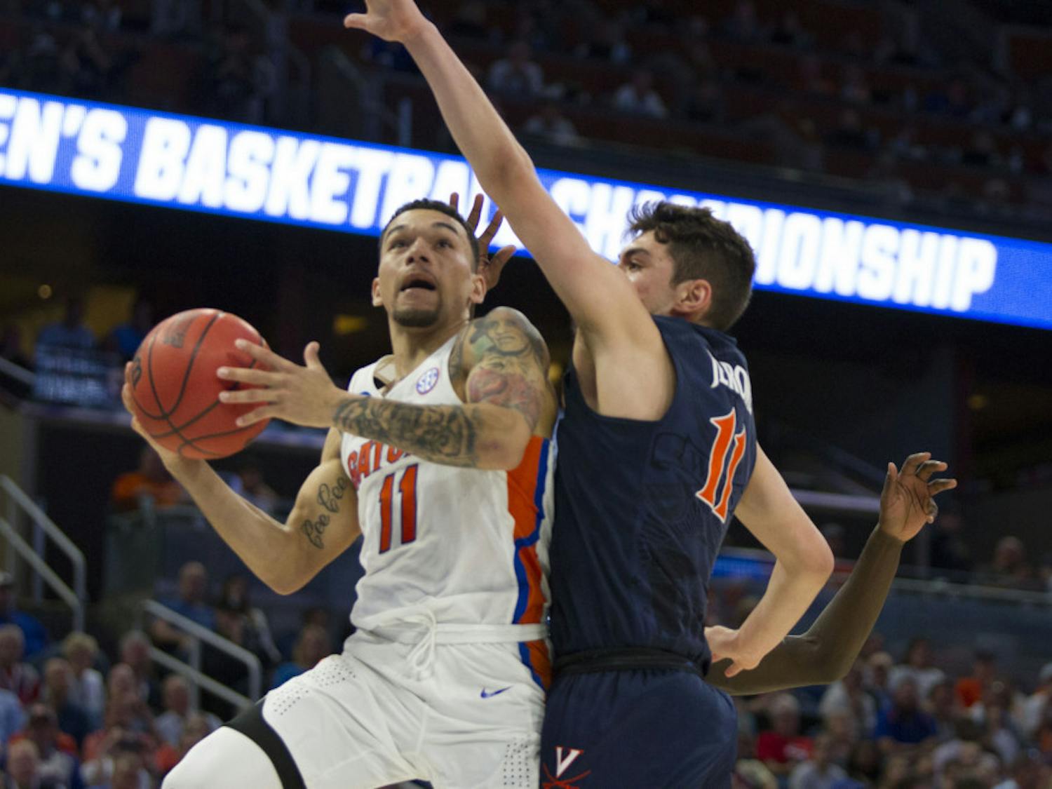 Point guard Chris Chiozza shoots a contested layup in Florida's 65-39 win over Virginia in the Round of 32 in the NCAA Tournament on Saturday in Orlando. 