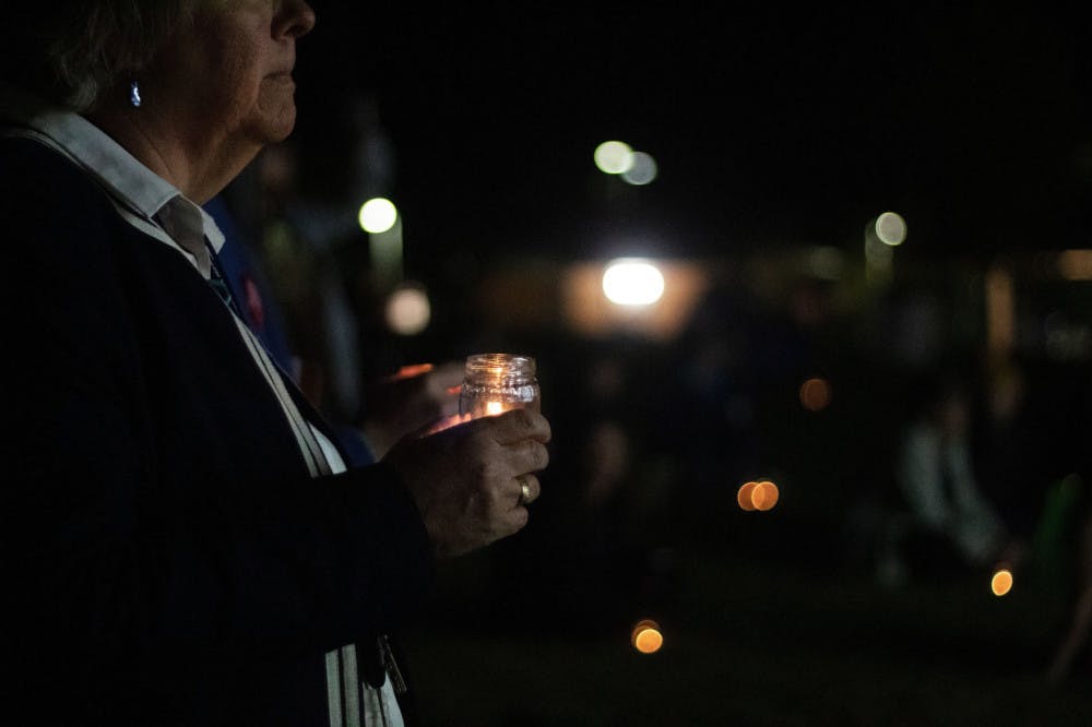 Flo Turcotte holds a candle for the vigil during the Transgender Day of Remembrance at Depot Park Wednesday night.