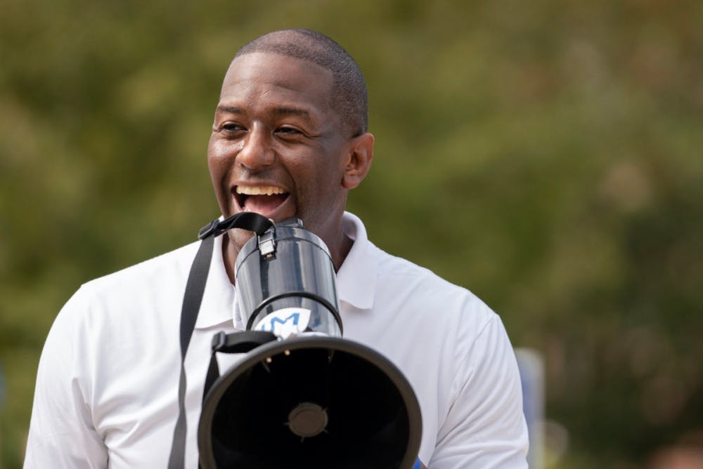 <p><span id="docs-internal-guid-28f2cfa3-7fff-bdfc-fa4a-50de3fb4d803"><span>Mayor of Tallahassee and gubernatorial candidate Andrew Gillum laughs while speaking at a rally on UF's campus Friday afternoon. During the event, hosted by the Andrew Gillum campaign, Gillum walked with students to the polls.</span></span></p>