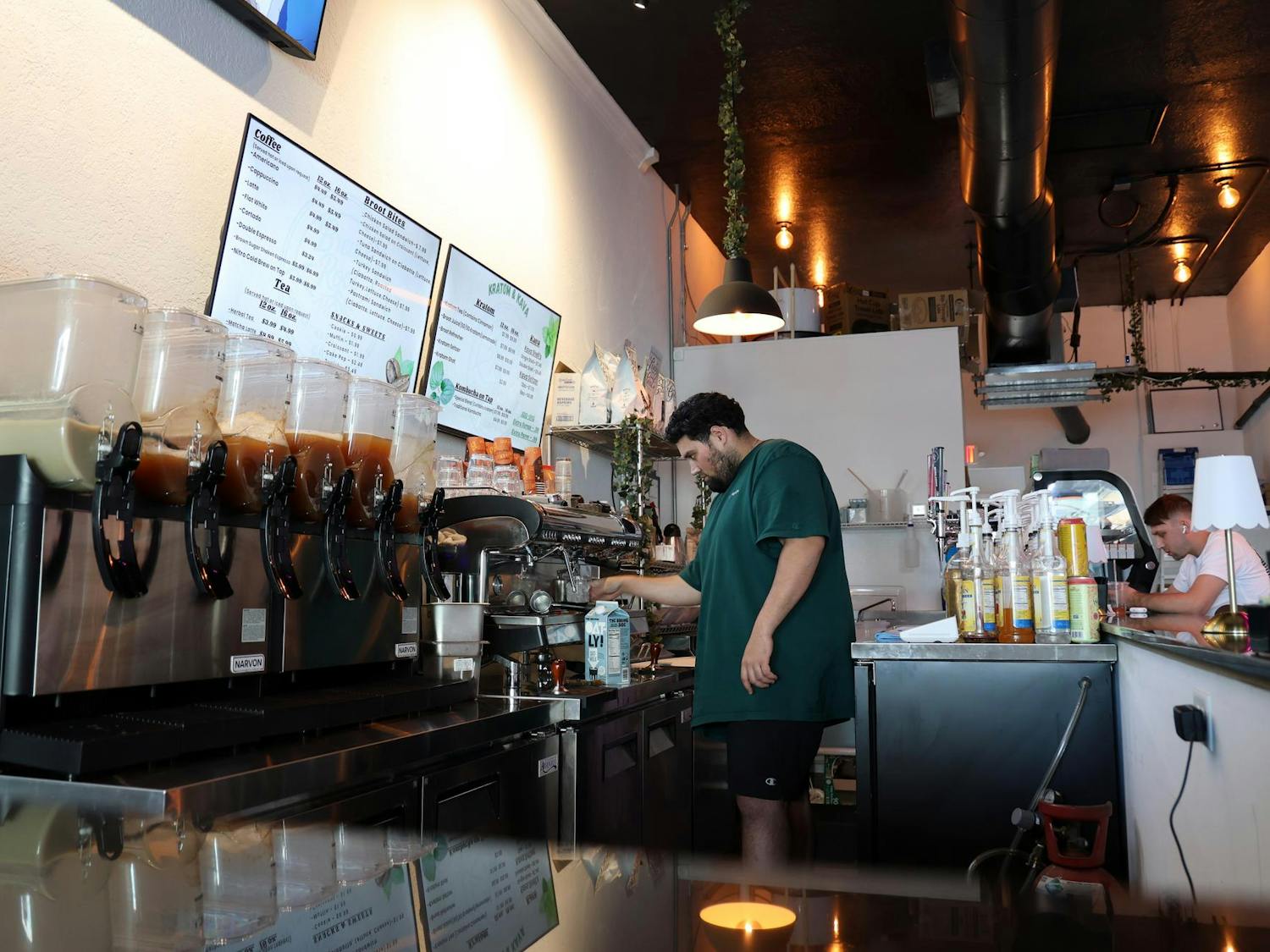 Brew&Root owner Bekir “Beck” Mansi works behind the counter inside the shop on West University Avenue in Gainesville, Fla., on Friday, Feb. 13, 2026.