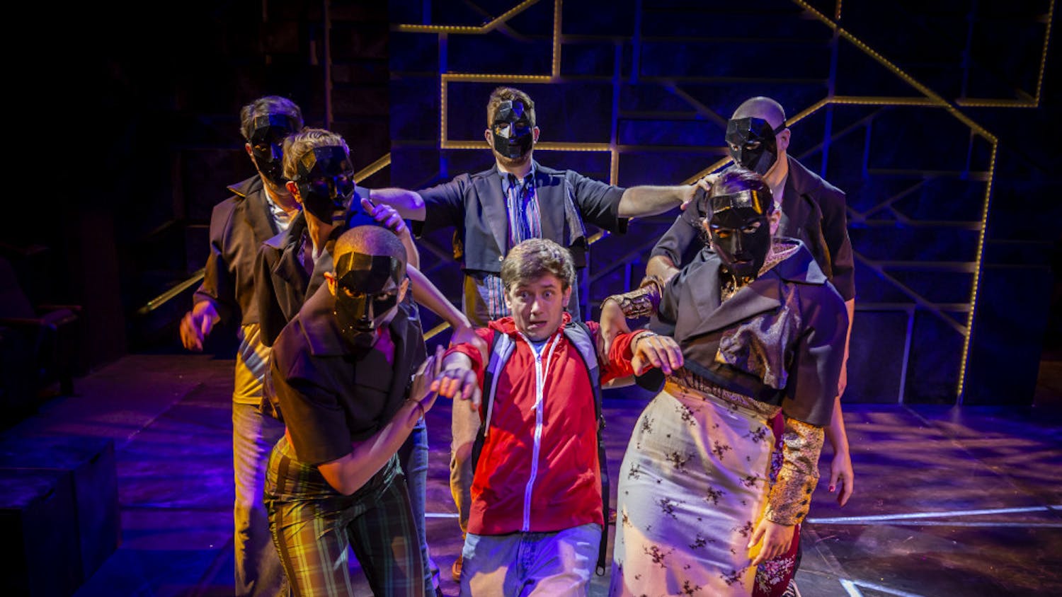 Actor Kyle Brumley (center) portrays 15-year-old Christopher in "The Curious Incident of the Dog in the Night-Time". This scene gives the audience a visual representation of the jarring experience Christopher has when interacting with the outside world.