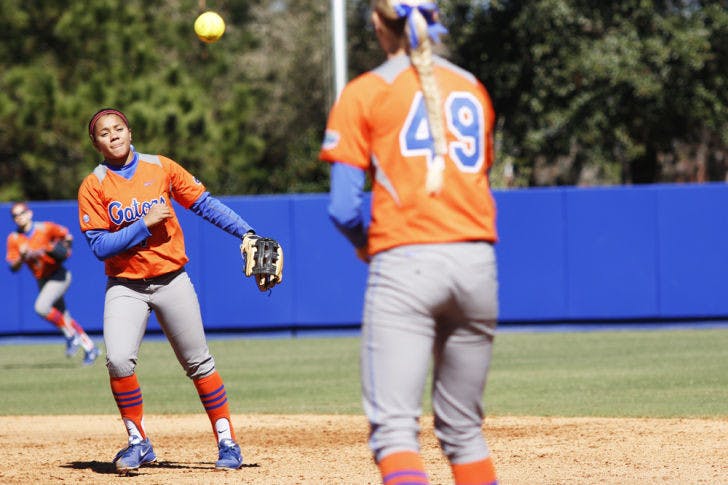 Freshman infielder Kelsey Stewart (7) throws a ball to freshman first baseman Taylor Schwarz (49) to end an inning during Florida’s 9-1 win over UNC Wilmington on Feb. 17 at Katie Seashole Pressly Stadium. Stewart is one of Florida's key underclassmen who have fueled the team's success this season.&nbsp;